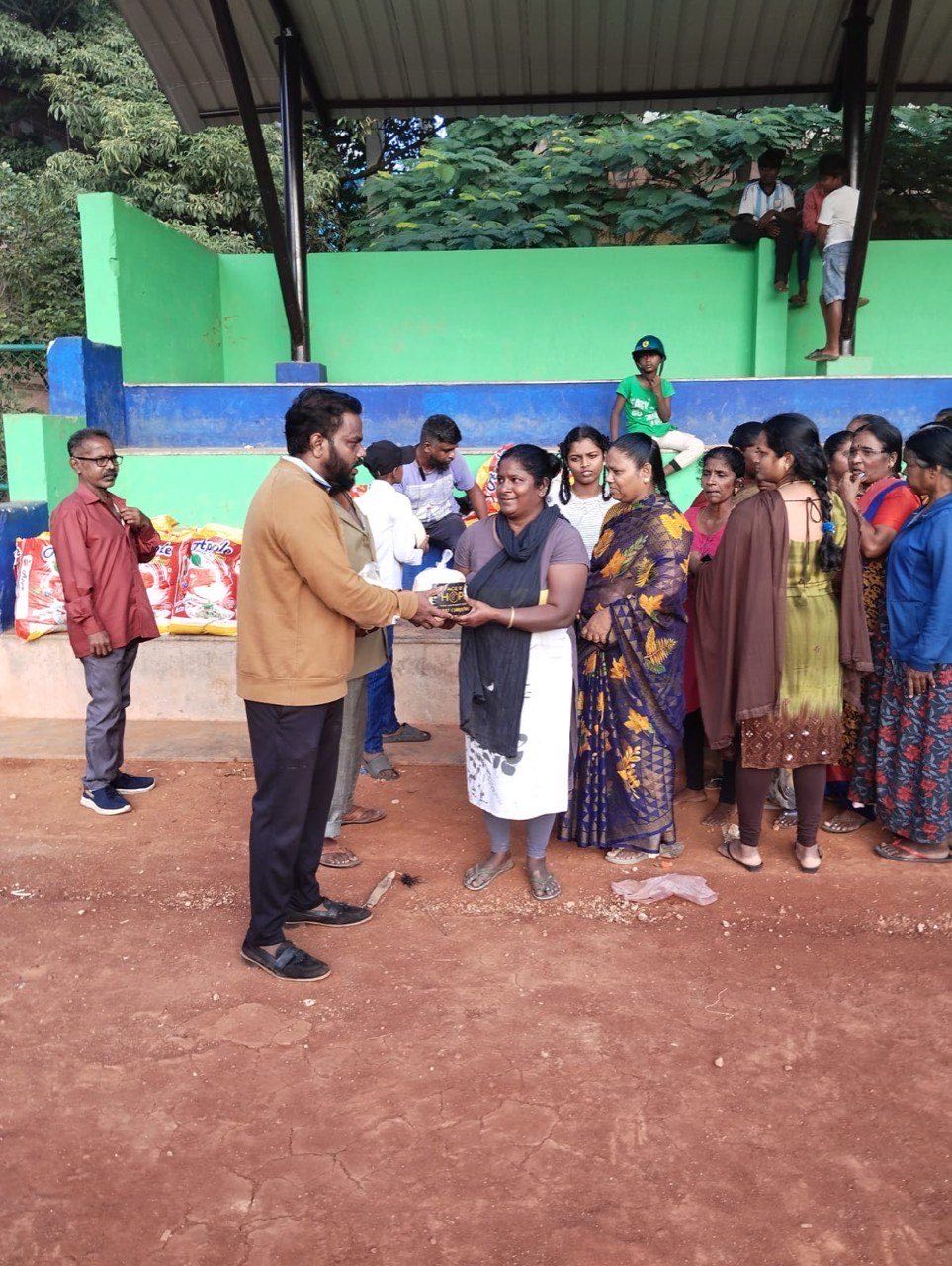 An outdoor community meeting supported by Face of Hope